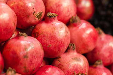 Fresh raw pomegranates fruit on market stall in Malaysia