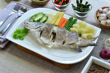 Steamed sea bassfish and boiled mixed vegetables