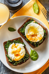 Healthy sandwich with spinach and poached eggs