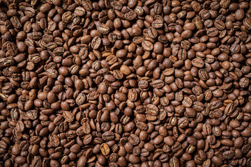 Roasted brown coffee beans, top view background