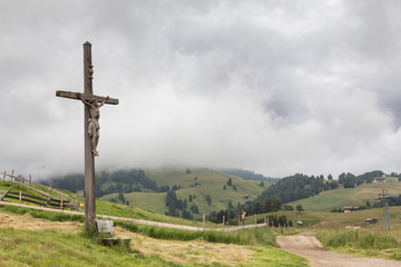 Fototapeta na wymiar statue of Jesus on cross wooden background on natural view and fog