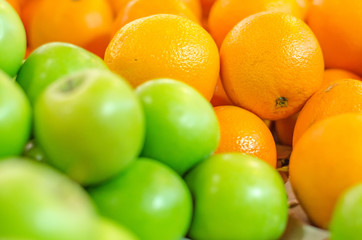 beautiful color combination, orange and green apple background display at market stall.