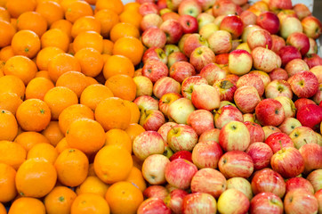 beautiful color combination, orange and red apple background display at market stall. selective focus shot