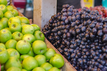 green apple and grapes background display on fresh market stall