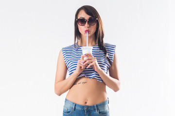 Young brunette model posing drinking cocktail studio shot on white background, not isolated