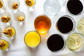 Top view of wine glasses filled with white wine and red wine and glasses of orange juice
