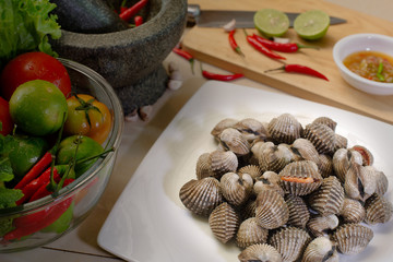 Fresh Cockles in the dish and Vegetables, ingredient prepare for seafood sauce Scald cockles / Selective focus .