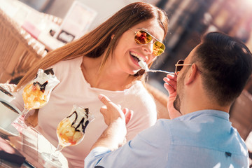 Dating in the cafe. Loving couple drinking coffee and eating fruit desserts. Dating, love, relationships