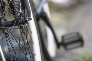 Fototapeta premium Close-up shot of front wheel of a bicycle with bokeh background.
