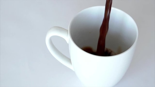Pouring energy coffee drink in white cup