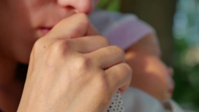 mother kisses child handle, mother resting with baby in Park