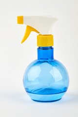 Blue spray bottle, white background. Plastic sprayer for housework.