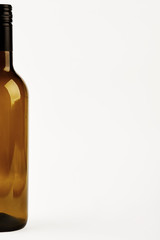 Half of dark bottle isolated. Cropped image of glass bottle.