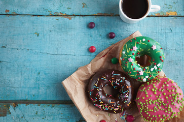 delicious homemade donuts on  rustic turquoise  wooden background. Delicious breakfast, top view, selective focus