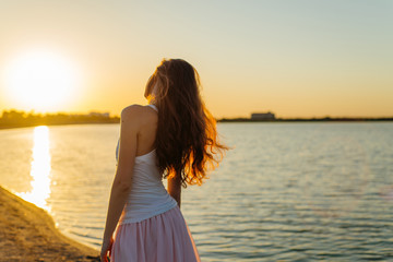 Woman with long hair at sunset