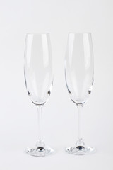 Two champagne glasses, front view. Crystal clear glasses for wine.