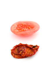 Fresh and dry tomato slices on white background.