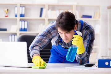 Male cleaner working in the office