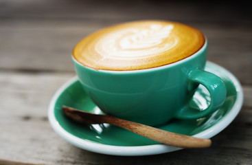Late coffee cup on old grunge woden