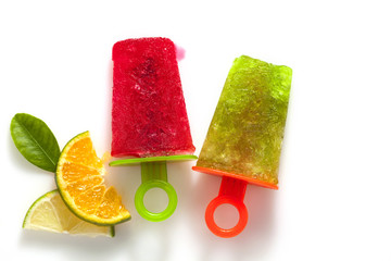 flat lay style of handmade ice cream with lime and orange fruit on white background.