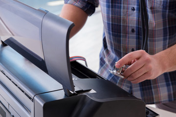 Repairman repairing broken color printer
