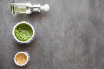 Natural skincare facial and body creams on dark background from above. Plant-based beauty products 