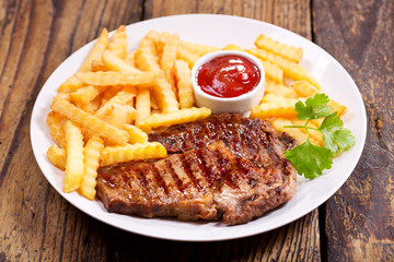 plate of grilled meat with french fries