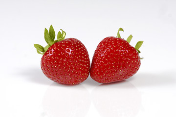 Two red  strawberries isolated on white background.