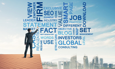 Young businessman standing on house roof and writing leadership 