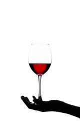 Girl holding a glass of red wine on a white background