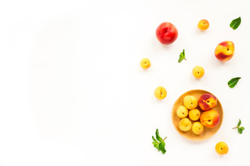 Fresh summer fruit. Peach, nectarine, apricot and mint on white background. Top view, flat lay,...