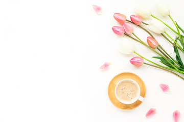 Cup of coffee, lilac and white tulip flowers, macaroon cake on white background. Flat lay, top view
