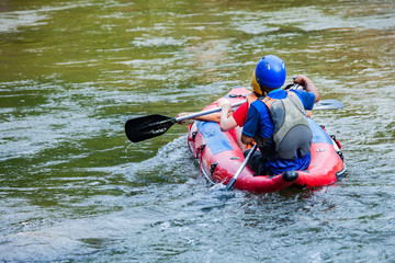 Group of traveler in the inflatable rafting on the river, extreme and fun sport