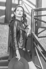 Outdoor portrait of fashionable woman posing in the old city