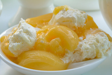 The souffle gentle on a delicate saucer closeup. Dessert jelly yellow - white color.