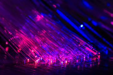 Luminous optical fiber on a black background