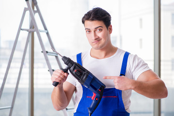 Young worker with hand drill