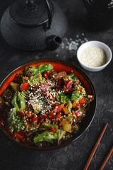 Noodles with vegetables and meat on a dark background, Asian food, Selective focus