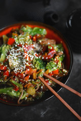 Noodles with vegetables and meat on a dark background, Asian food, Selective focus