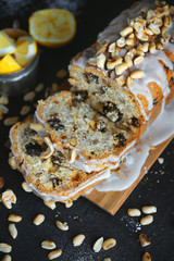 Homemade cake with raisins and nuts with lemon icing on a dark background, Pastry, Atmospheric photo, Lemon cake, In a cut, Selective focus, Vertical