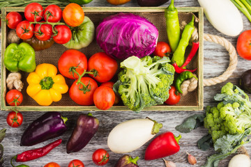 Set of raw vegetables in the wooden tray