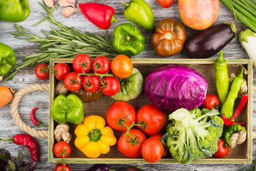 Set of raw vegetables in the wooden tray