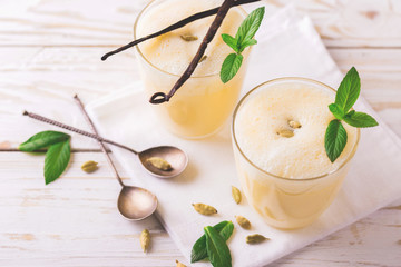 Traditional Indian mango lassi with cardamon, mint, vanilla and saffron