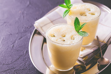 Traditional Indian mango lassi with cardamon, mint, vanilla and saffron