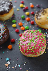 Donuts and colorful sprinkles on dark stone background, Party, Close-up, Selective focus