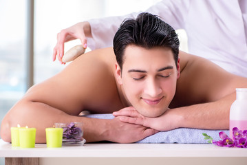 Fototapeta na wymiar Handsome man in spa massage concept