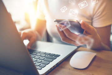 Closeup Woman hand using smart phone with sending email icon, Email concept