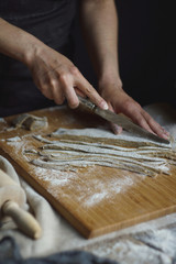 Women's hands are preparing home-made raw noodles, Rustic, Selective Focus, Atmospheric dark tone
