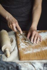 Women's hands are preparing home-made raw noodles, Rustic, Selective Focus, Atmospheric dark tone