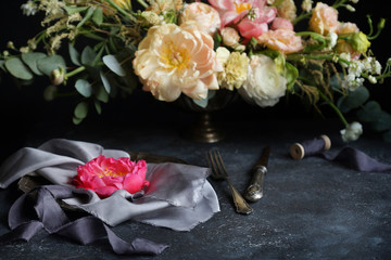Wedding decor, Pink peony on silk napkins and flower arrangement on a dark background, Wedding bouquet, Decorator, Selective focus